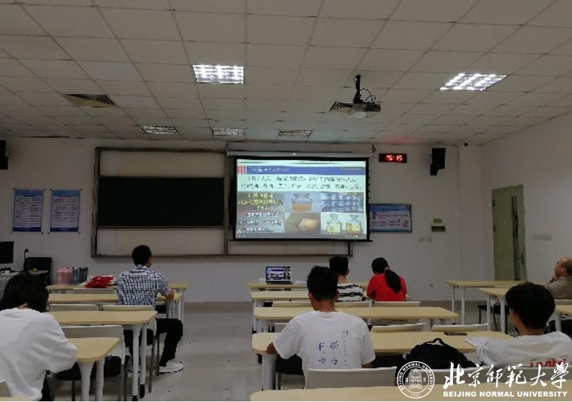 A classroom with a projector screen&#xA;&#xA;Description automatically generated with low confidence