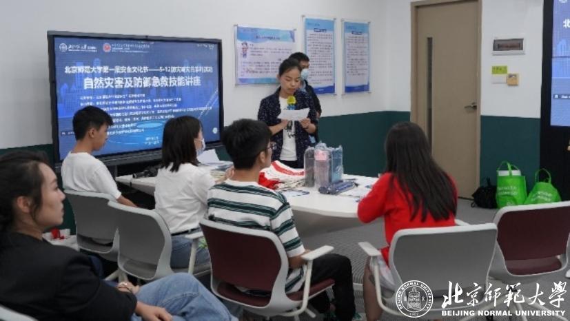 A group of people sitting in a room looking at a screen&#xA;&#xA;Description automatically generated with low confidence